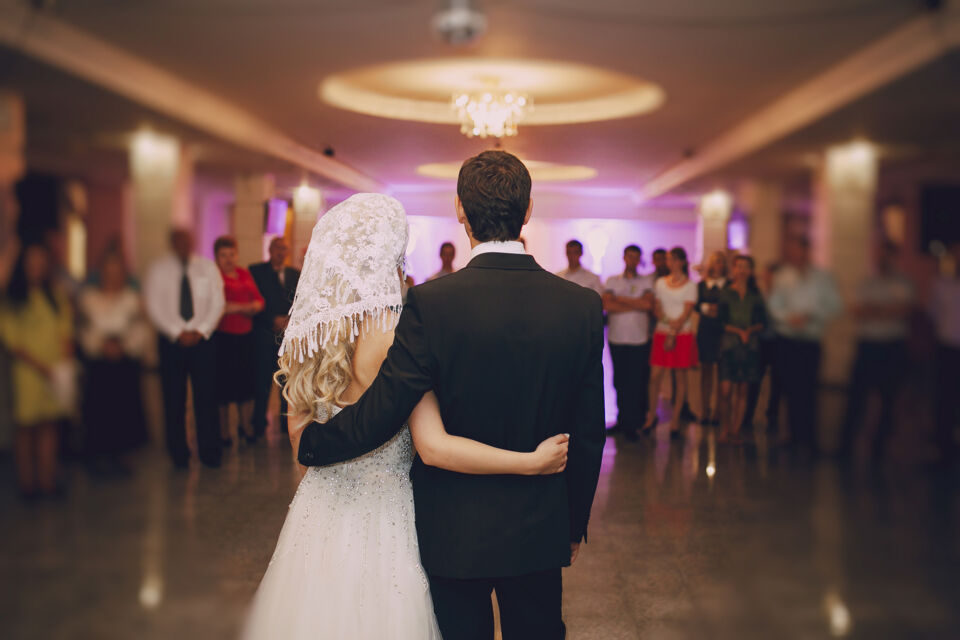 Freepik - Photo d'illustration - Jeune couple de mariés, qui a choisi un mariage sans thème ni couleur, entouré de ses invités ravis et admiratifs.