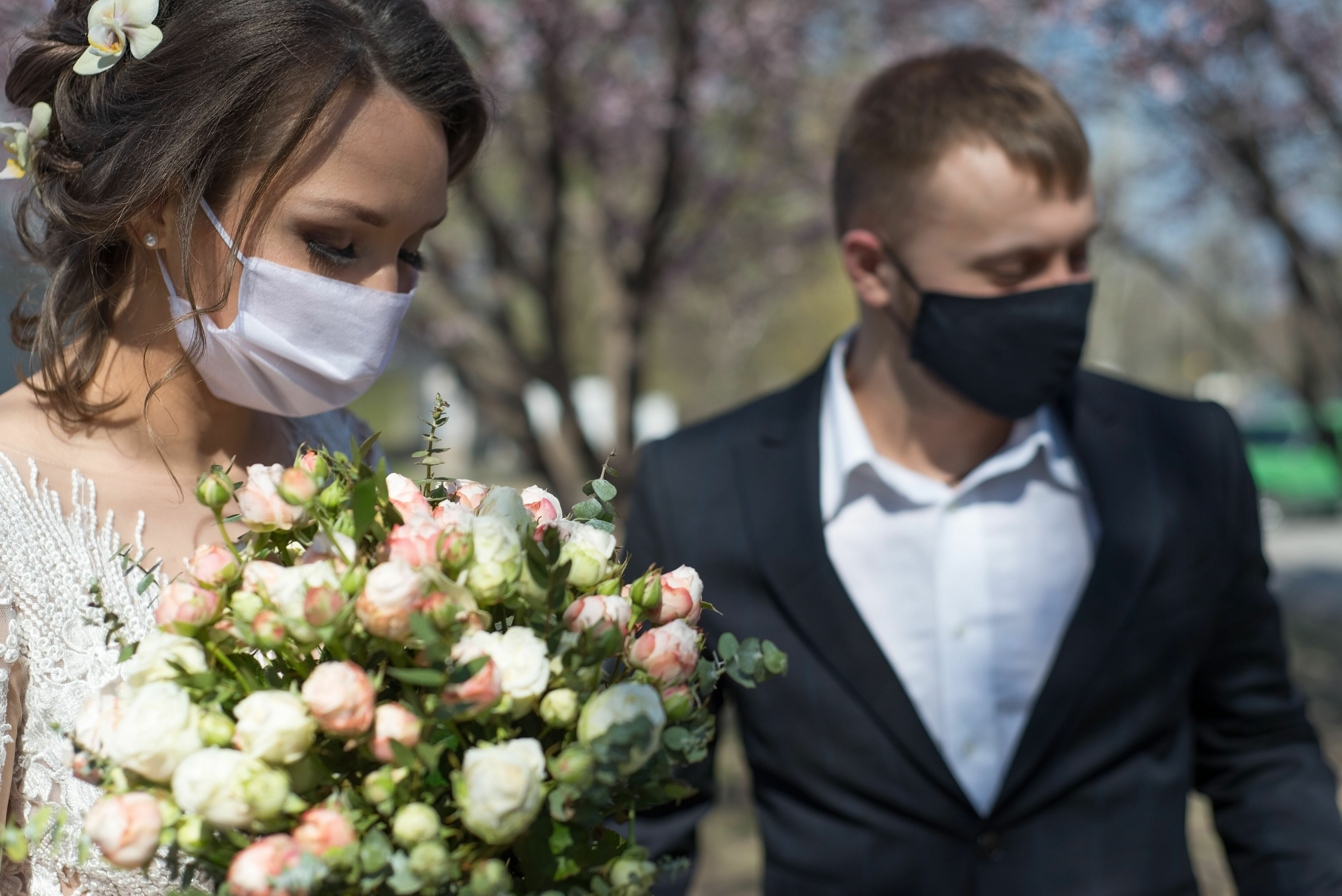 Adobe Stock - Photo d'illustration - Arborant des masques de protection respiratoire, un couple d'amoureux célèbre son mariage.
