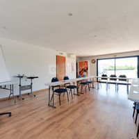 Salle lumineuse donnant sur des champs